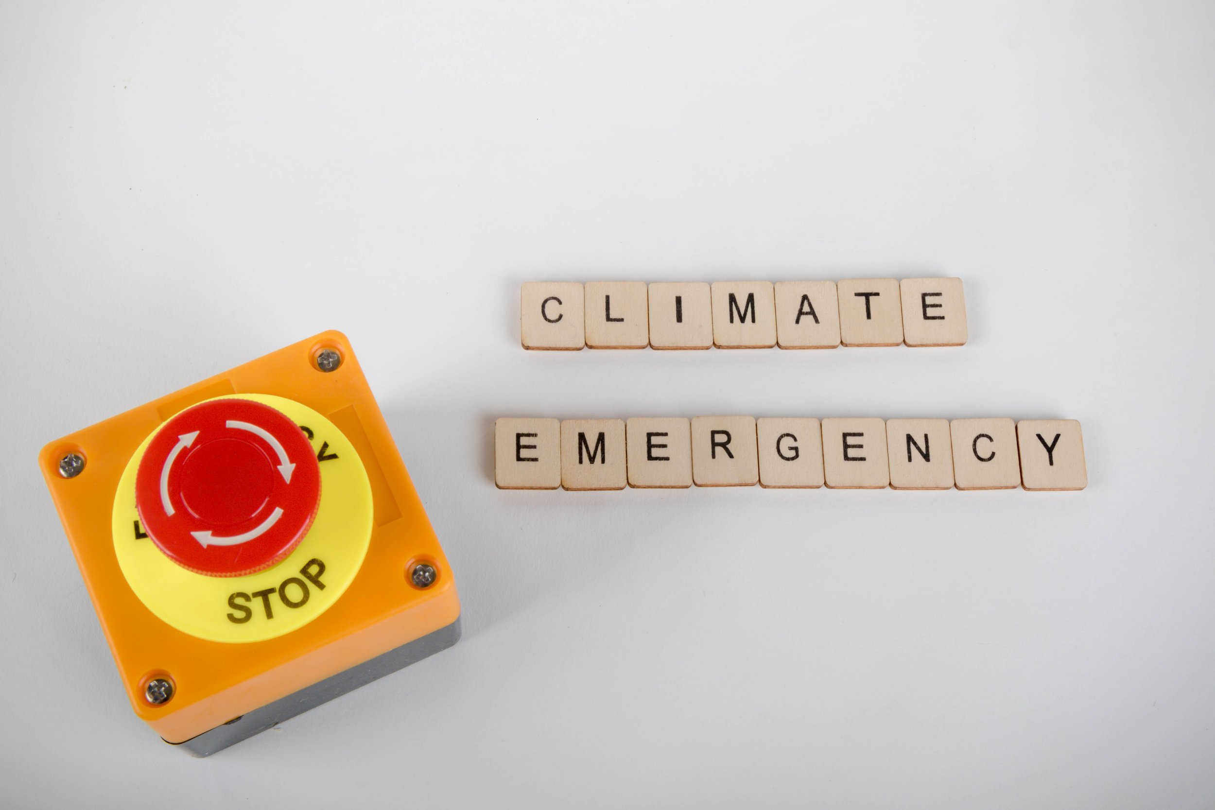 An,Industrial,Emergency,Stop,Button,With,A,Sign,Reading,Climate